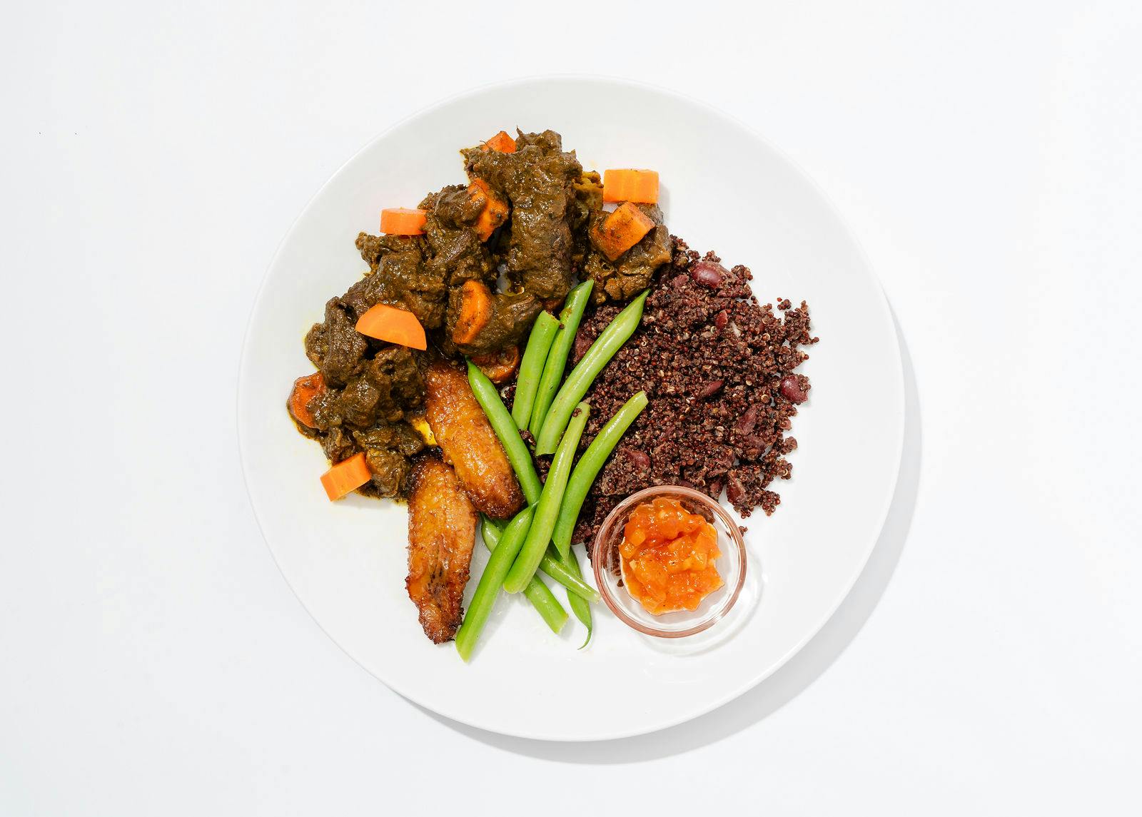 Home Style Curried Goat with Carrot Quinoa & Peas